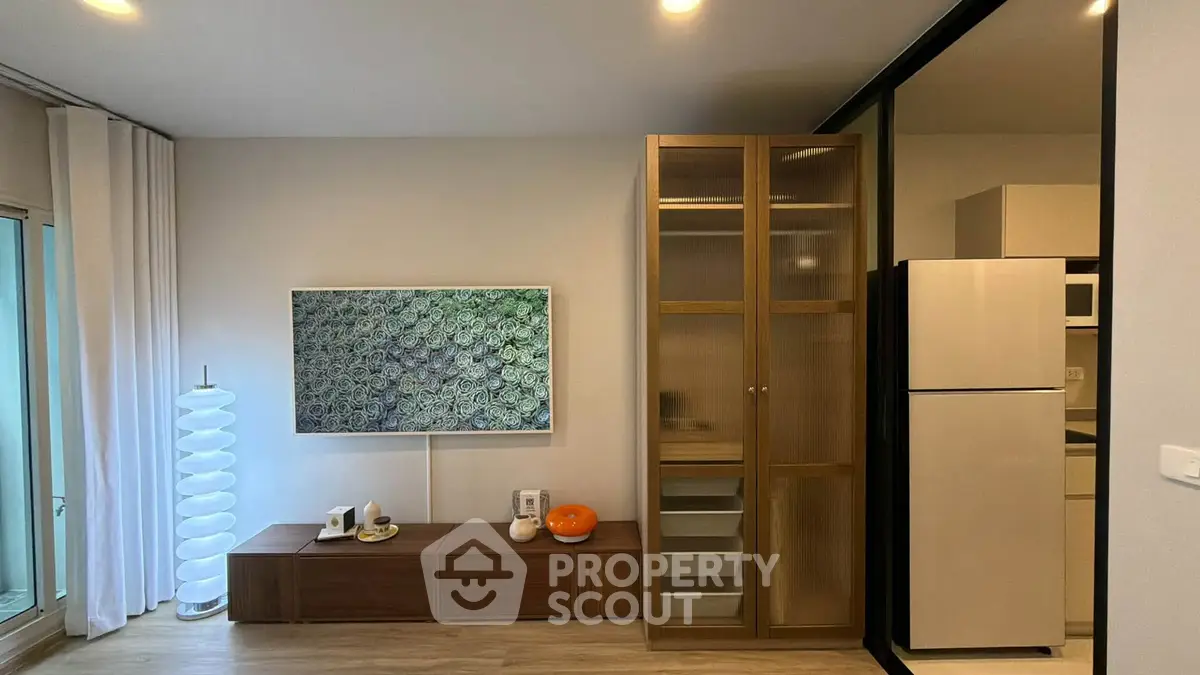 Modern living room with stylish decor and sleek kitchen appliances