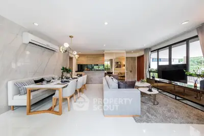 Luxurious open-plan living room with modern dining area and stylish decor