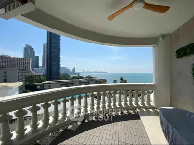 Stunning balcony view of city skyline and ocean, perfect for relaxation.