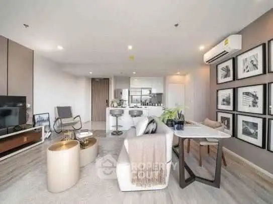 Modern open-plan living room with stylish decor and kitchen area