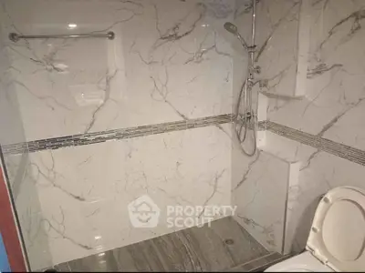 Modern bathroom with marble tiles and sleek shower design