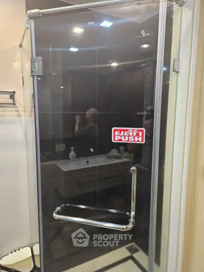 Modern bathroom with glass shower door and sleek fixtures