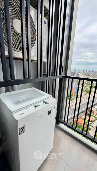 Modern balcony with washing machine and city view, perfect for urban living convenience.