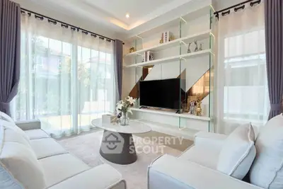 Luxurious living room with modern decor and large windows for natural light.