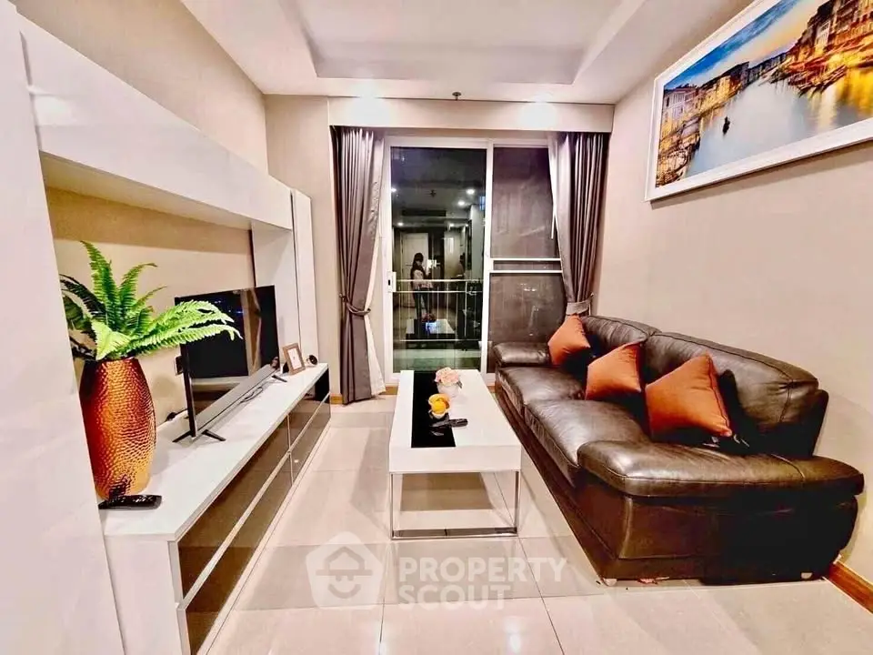 Modern living room with sleek leather sofa and stylish decor in a cozy apartment.