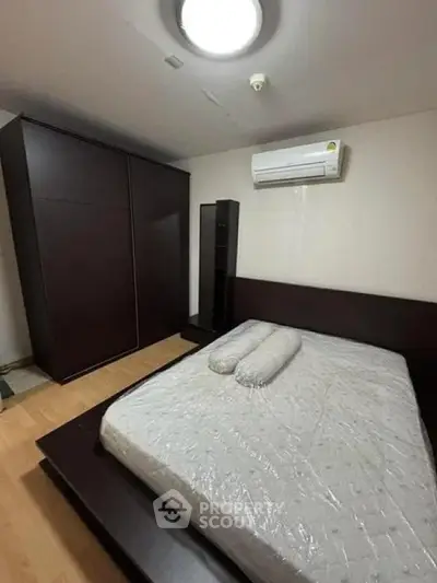 Spacious bedroom with modern furniture and air conditioning, perfect for comfort and relaxation.