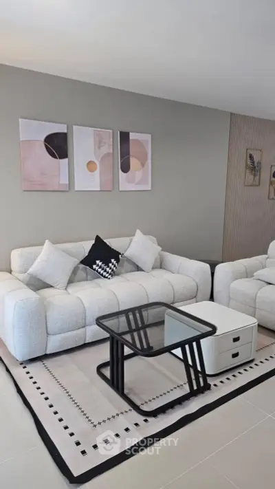 Modern living room with stylish furniture and abstract art, perfect for contemporary living.
