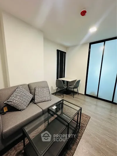 Modern living room with sleek furniture and stylish decor in a contemporary apartment.