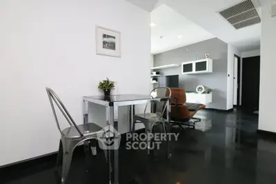 Modern living room with sleek black flooring and stylish furniture