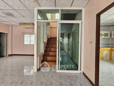Spacious interior with staircase and sliding glass door, ideal for modern living.