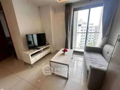 Modern living room with sleek furniture and city view from balcony.