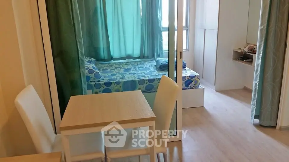 Cozy bedroom with glass partition and dining area in modern apartment