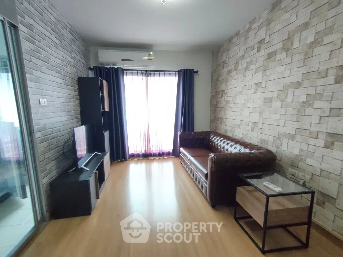 Stylish living room with brick accent wall and leather sofa in modern apartment.