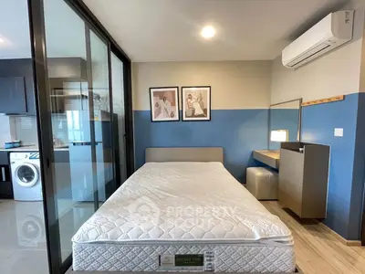 Modern bedroom with glass partition, air conditioning, and stylish decor in a contemporary apartment.