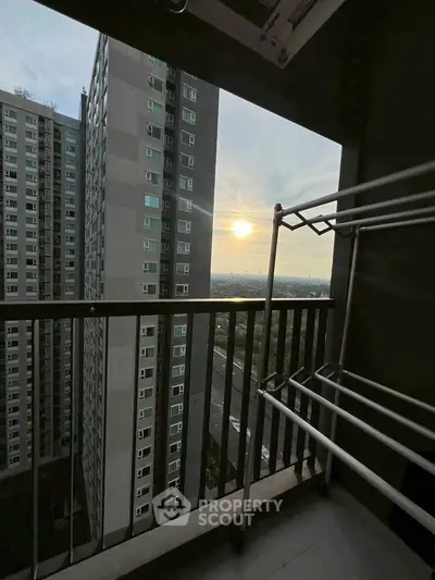High-rise apartment balcony with stunning city view at sunset