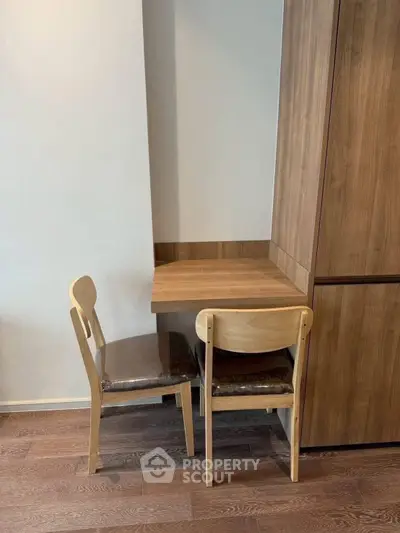 Cozy study nook with wooden desk and chairs in modern apartment