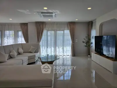 Spacious modern living room with elegant decor and large windows