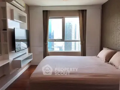 Modern bedroom with city view, featuring sleek design and natural light.