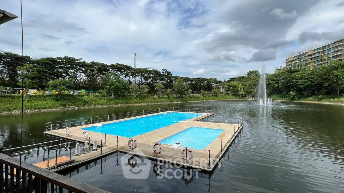 Stunning floating pool with scenic lake view and lush greenery.