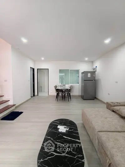 Spacious modern living room with open layout and sleek furniture, perfect for contemporary living.