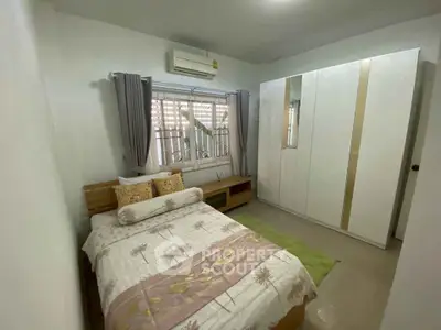 Cozy bedroom with modern wardrobe and air conditioning, perfect for restful nights.