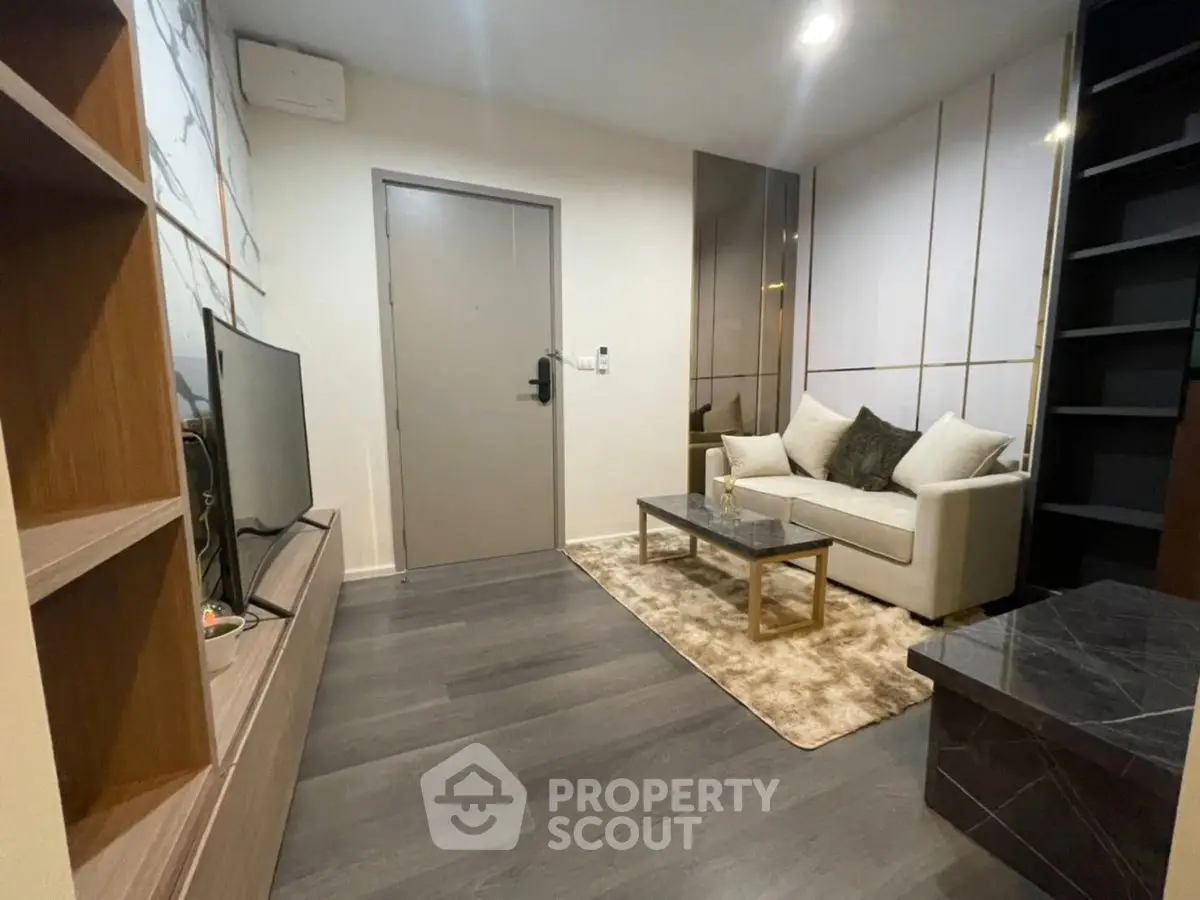 Modern living room with sleek design, cozy sofa, and stylish decor in a contemporary apartment.