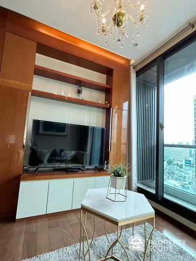 Luxurious living room with modern TV setup and city view balcony