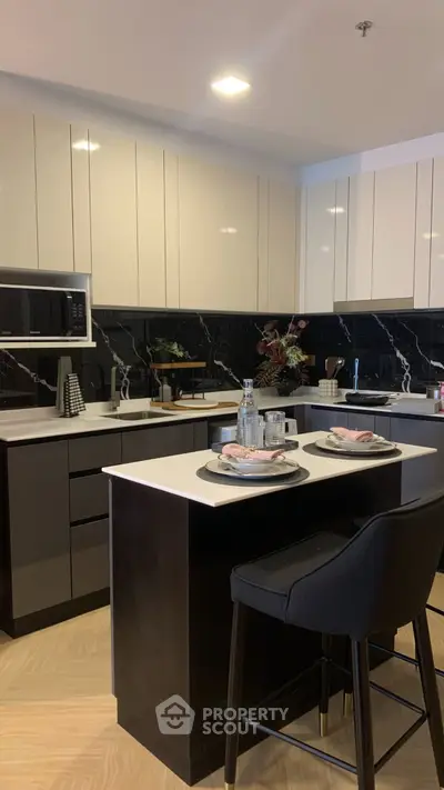 Modern kitchen with sleek cabinetry and stylish island seating