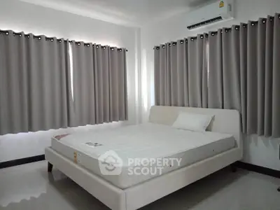 Spacious bedroom with modern design and ample natural light