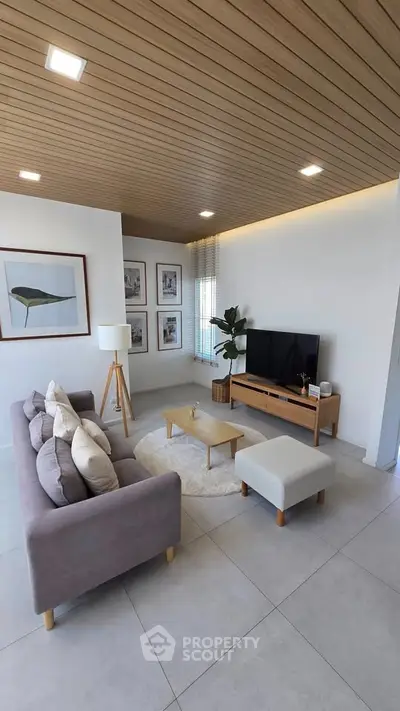 Modern living room with stylish decor and wooden ceiling