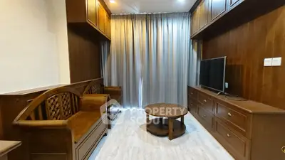 Charming living room with elegant wooden furniture and modern TV setup, perfect for cozy relaxation.