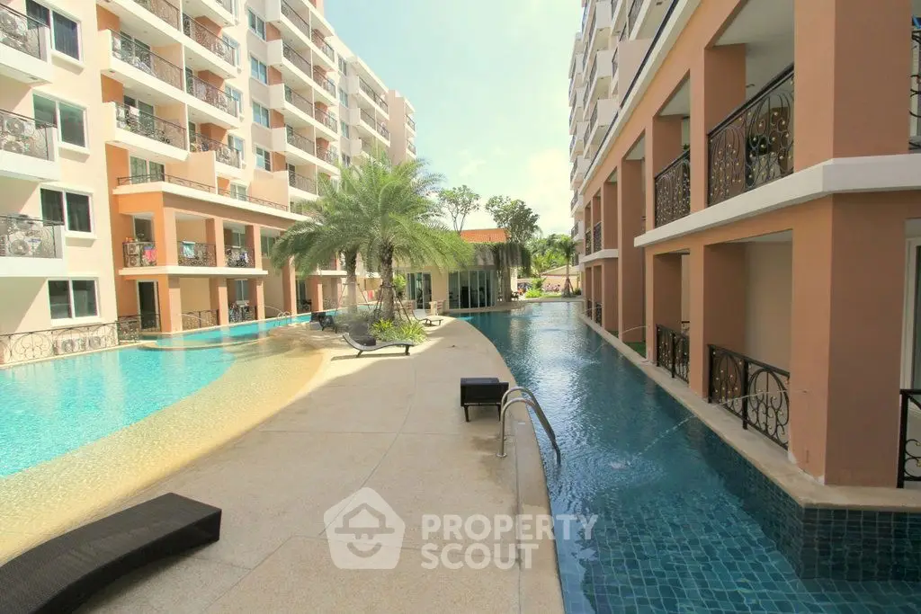 Luxurious apartment complex with stunning poolside view and modern architecture.