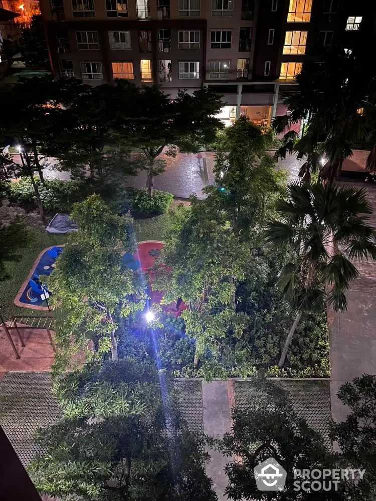 Night view of residential building with lush garden and pathway