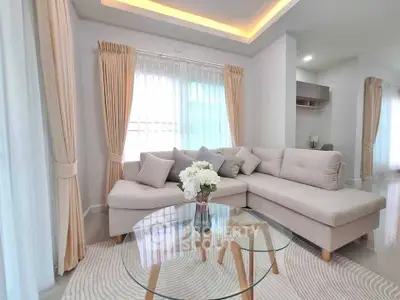Elegant living room with modern L-shaped sofa and glass coffee table, featuring soft lighting and stylish decor.