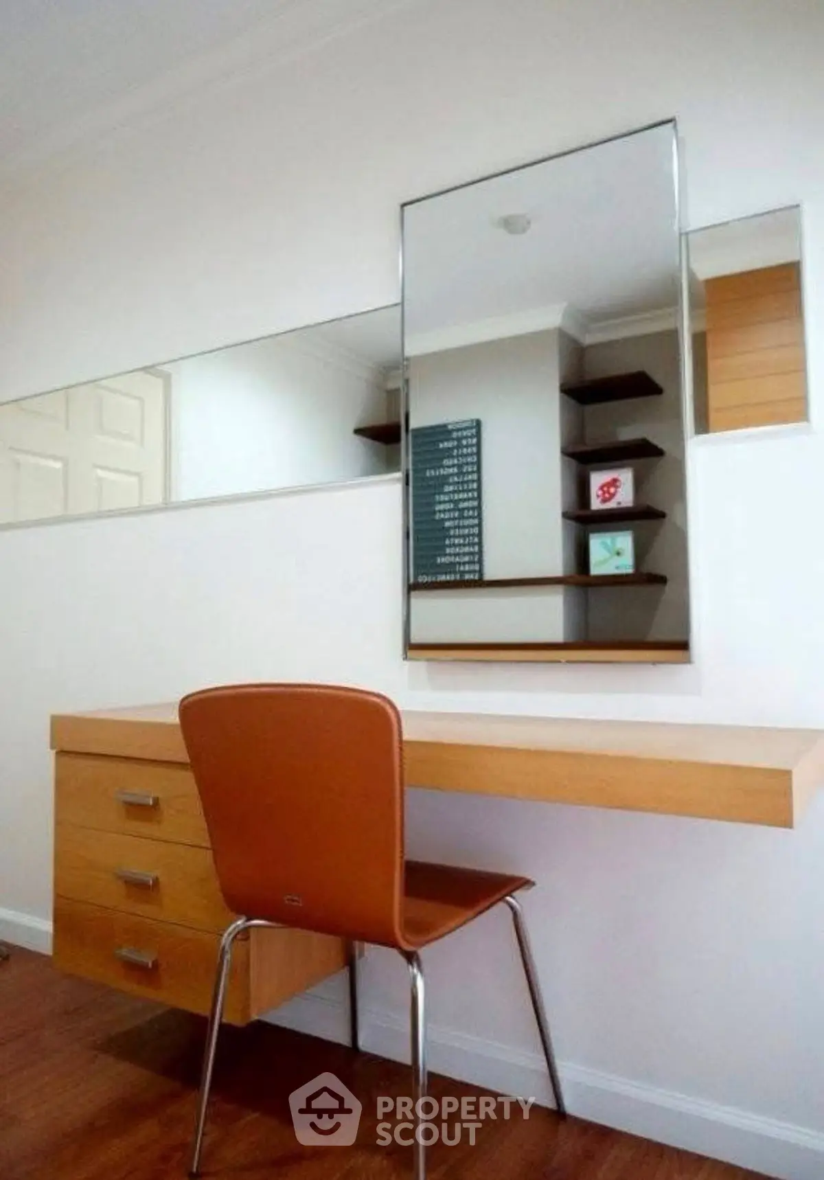 Modern study area with sleek desk and mirror in stylish home office.