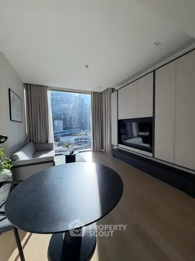 Modern living room with large window offering city view, sleek furniture, and natural light.