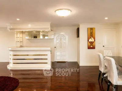 Elegant living room with polished wooden floors and stylish bar area