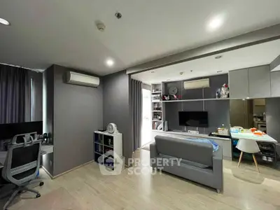 Modern living room with sleek furniture and open layout, featuring a cozy workspace and entertainment area.