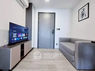 Modern living room with sleek furniture and smart TV, perfect for urban living.