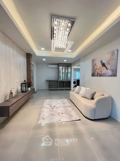 Elegant living room with modern chandelier and stylish decor