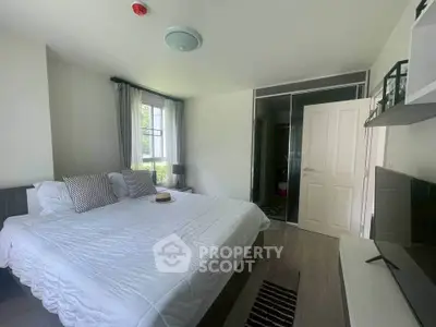 Spacious bedroom with modern decor and natural light