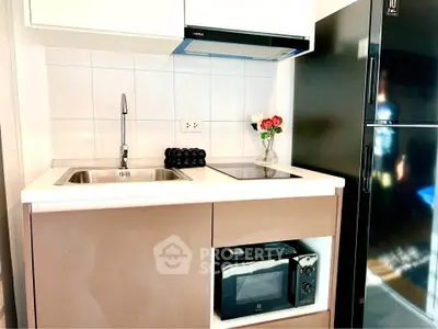 Modern compact kitchen with sleek appliances and stylish cabinetry