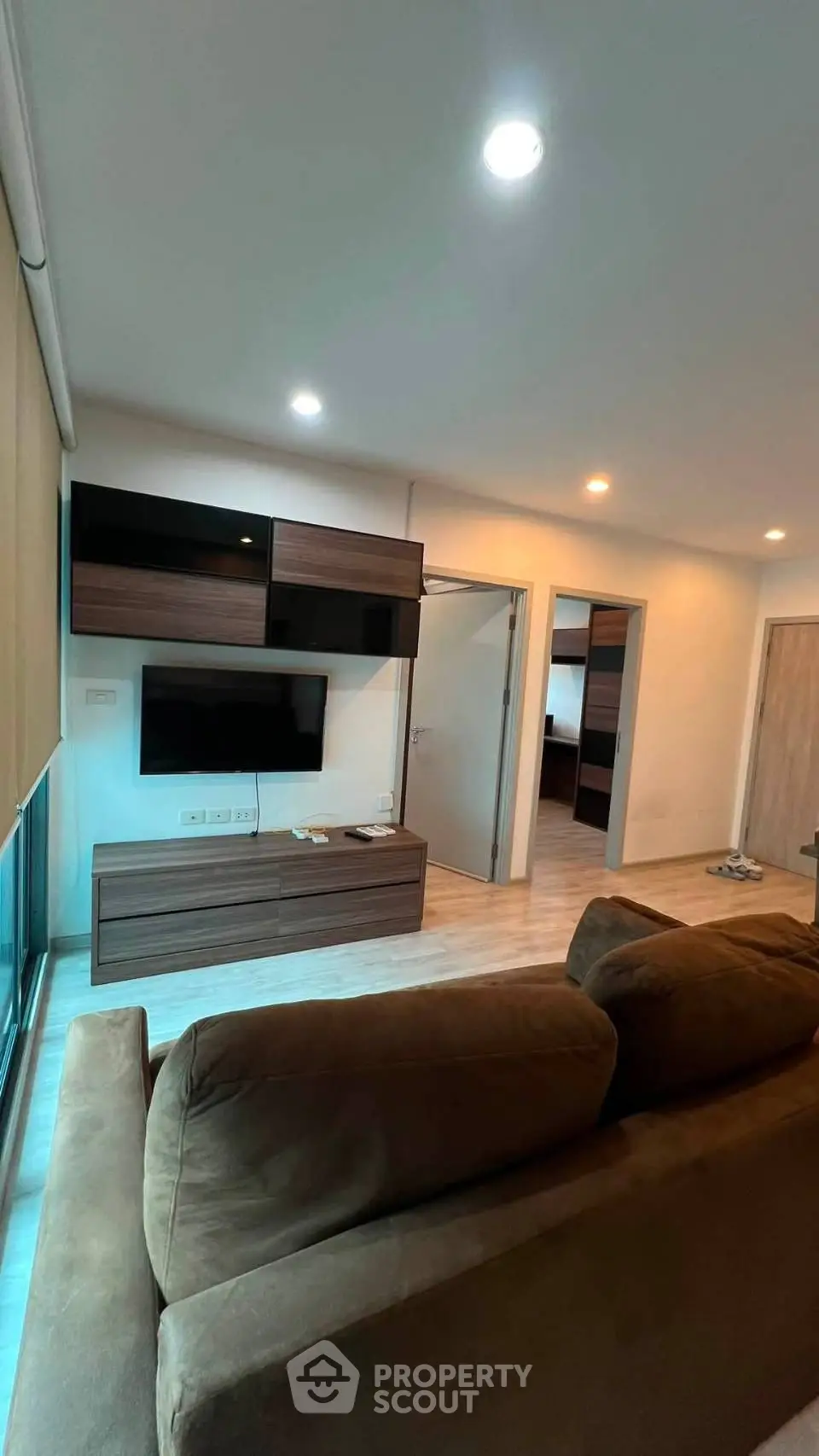 Modern living room with sleek furniture and ambient lighting in a stylish apartment.