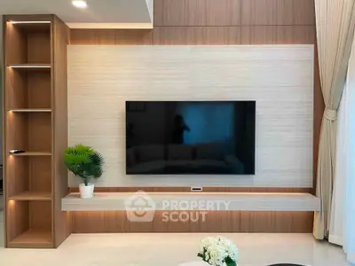 Modern living room with sleek TV setup and elegant wood paneling