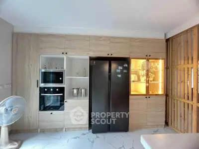 Modern kitchen with sleek appliances and stylish cabinetry, perfect for culinary enthusiasts.