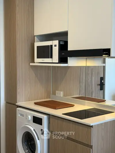 Modern kitchen with built-in appliances and sleek wooden cabinetry