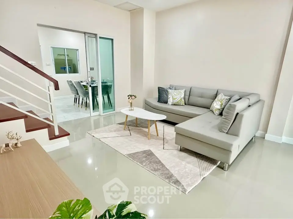 Modern living room with sleek gray sectional sofa and stylish decor