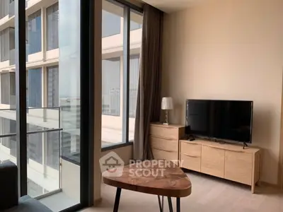 Modern living room with large windows and stylish furniture in a high-rise apartment.