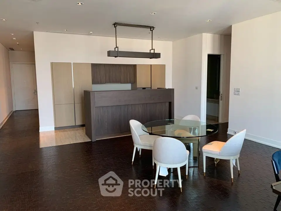 Modern living room with elegant dining area and stylish lighting in a luxury apartment.