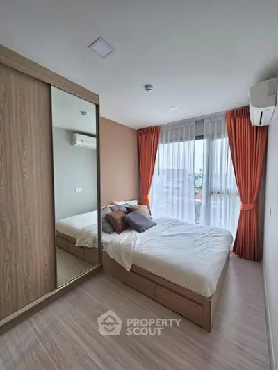 Modern bedroom with large window and mirrored wardrobe
